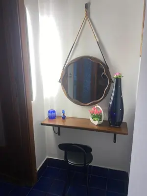a mirror on a shelf in a room at Dolce Sicily a 2km dal centro in Palermo