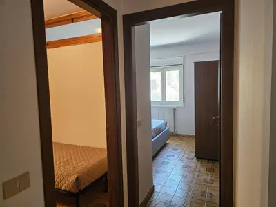 a room with a bed and a door to a bedroom at Guests's Nest in Castellammare del Golfo