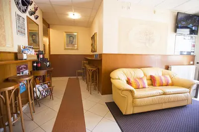 a living room with a couch and a bar at Albergo La Principessa in Alcamo