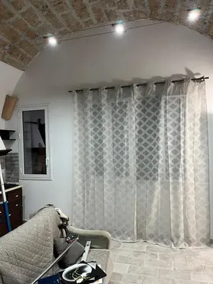 a living room with a couch and a window at Casa vacanze Giada in Terrasini
