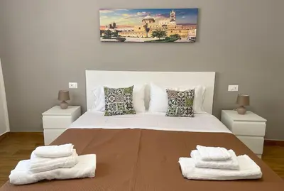 a bedroom with a large bed with towels on it at Casa vacanze Casuzza Sferracavallo Palermo in Palermo
