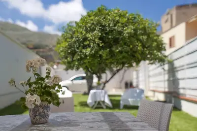 a table with a vase of flowers on top of it at Casa vacanze Casuzza Sferracavallo Palermo in Palermo