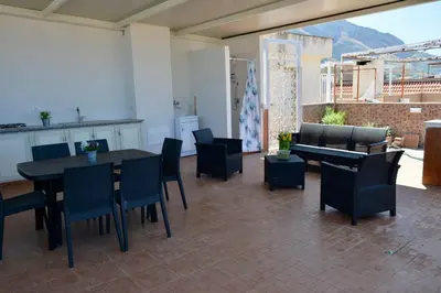 a living room with a table and chairs at La Casetta di Ale in Isola delle Femmine