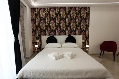 a bedroom with a bed with two towels on it at De Spuches House in Caccamo