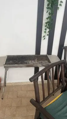 a wooden bench sitting next to a chair at Casa Joe in San Vito lo Capo