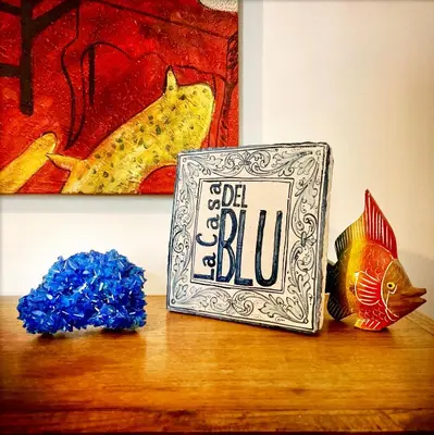 a clock sitting on top of a table with blue flowers at Casa del Blu in Palermo