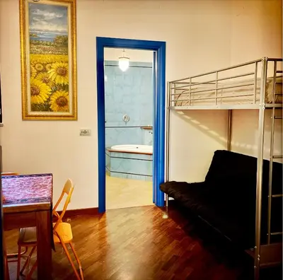 a living room with a bunk bed and a bathroom at Casa del Blu in Palermo
