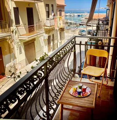 a plate of food on a table on a balcony at Casa del Blu in Palermo