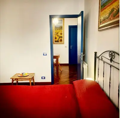 a living room with a red couch and a table at Casa del Blu in Palermo