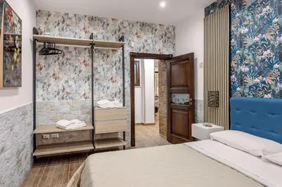 a bedroom with a bed and a bathroom at Luxury House Ballarò in Palermo
