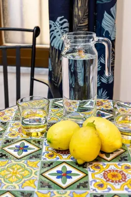 a table with lemons and a jug of lemon juice at Luxury House Ballarò in Palermo