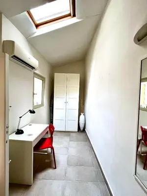 a room with a desk and a red chair at Casetta Bontà in Palermo
