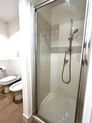 a shower stall in a bathroom with a toilet at Casetta Bontà in Palermo
