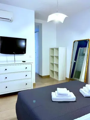 a bedroom with a bed and a dresser with a mirror at Casetta Bontà in Palermo
