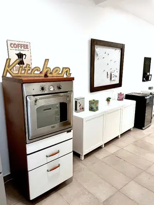 a room with a tv and some white cabinets at Casetta Bontà in Palermo
