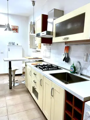 a kitchen with a sink and a stove top oven at Casetta Bontà in Palermo
