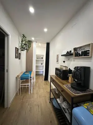 a living room with a kitchen and a dining room at Scillò House in Palermo