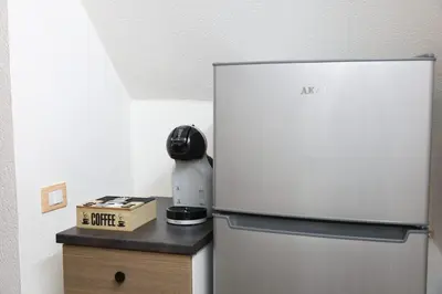 a refrigerator with a phone on top of a counter at G e B Central Apartment in Palermo