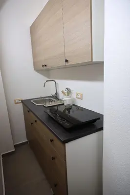 a kitchen with a sink and a counter top at G e B Central Apartment in Palermo