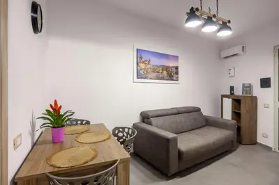 a living room with a couch and a table at G e B Central Apartment in Palermo