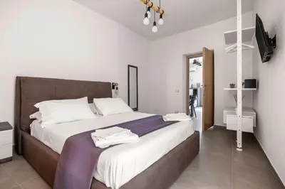 a bedroom with a large bed with white sheets at G e B Central Apartment in Palermo