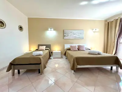 a room with two beds in a room at B&B Blue in Terrasini