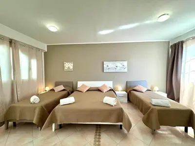 a bedroom with two beds with towels on them at B&B Blue in Terrasini