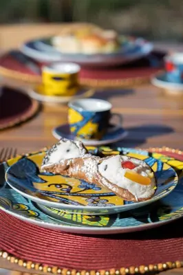 a plate of food sitting on a table at Villa Eos con piscina privata in Scopello