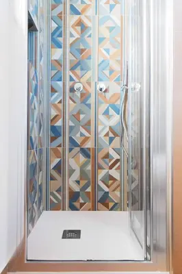 a shower with a glass door in a bathroom at Villa Eos con piscina privata in Scopello