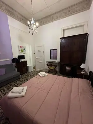 a bedroom with a large bed in a room at B&B Salinas in Palermo