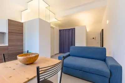 a living room with a blue couch and a wooden table at Loft Piazza Marina By DomuSicily in Palermo