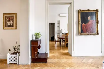 a living room with a painting on the wall at Elvi Penthouse by DomuSicily in Palermo