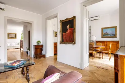 a living room with a painting on the wall at Elvi Penthouse by DomuSicily in Palermo