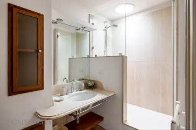 a bathroom with a sink and a shower at Elvi Penthouse by DomuSicily in Palermo