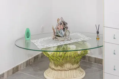 a glass table with some figurines on top of it at La Casa di Sciù Sciù in Palermo