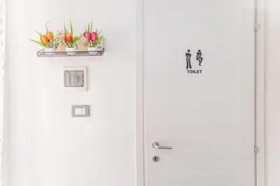 a white door with two plants on it at La Casa di Sciù Sciù in Palermo