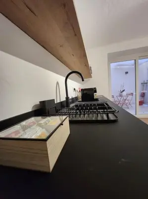a kitchen with a stove and a book on a counter at La Casa Di Mitì in Palermo