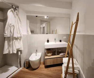 a bathroom with a sink and a toilet and a mirror at La Casa Di Mitì in Palermo