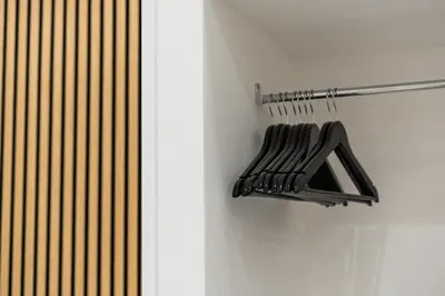 two pictures of a black rack on a wall at Ambrosia Suite in Palermo