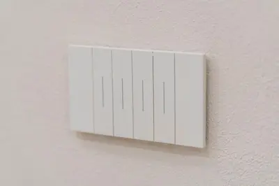 a white lightswitch on the side of a wall at Ambrosia Suite in Palermo