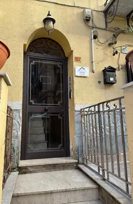 a black door on the side of a building at Ludo Holiday House - Charming con patio a due passi dalla cattedrale in Palermo