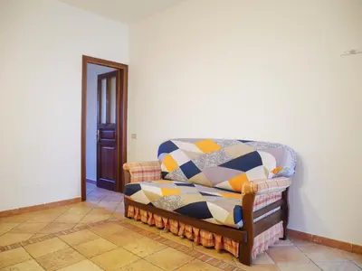 a couch with a blanket on it in a room at Casa del pescatore - fronte mare di Mondello - By Rentalbeb italy- in Palermo