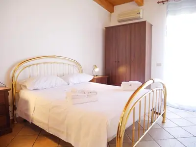 a bedroom with a white bed with two towels on it at Casa del pescatore - fronte mare di Mondello - By Rentalbeb italy- in Palermo