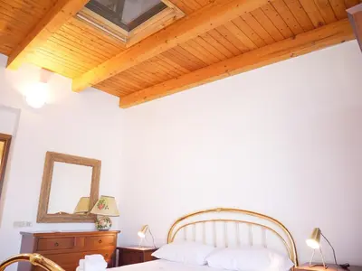 a bedroom with a bed and a wooden ceiling at Casa del pescatore - fronte mare di Mondello - By Rentalbeb italy- in Palermo