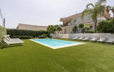 a yard with a swimming pool and chairs and a house at IRIS HOME Private Pool in Alcamo