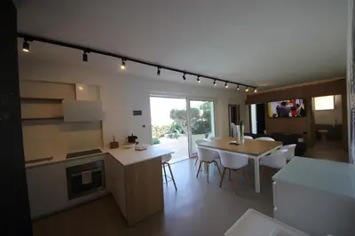 a kitchen and living room with a table and a dining room at IRIS HOME Private Pool in Alcamo