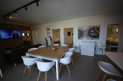 a dining room with a wooden table and white chairs at IRIS HOME Private Pool in Alcamo