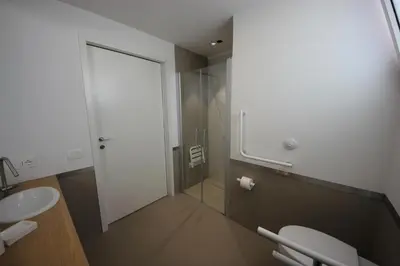 a bathroom with two toilets and a glass door at IRIS HOME Private Pool in Alcamo
