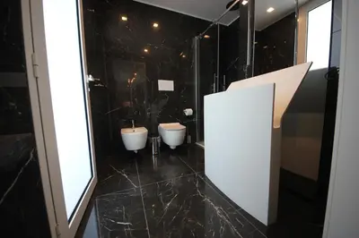 a bathroom with two sinks and two toilets at IRIS HOME Private Pool in Alcamo