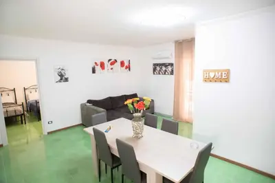 a living room with a table with chairs and a couch at Case D'irene in Capaci